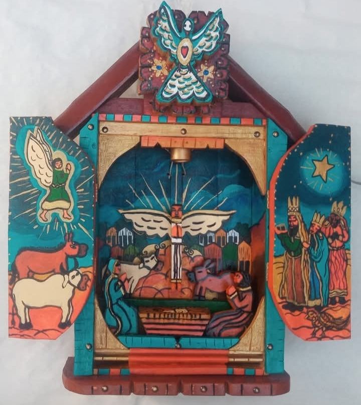 Oratório aberto com um presépio: anjo e bois pintados na porta esquerda, os três Reis Magos e a estrela na direita, e uma pomba no alto
